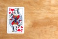 Minsk Belarus Ã¢â¬â October 1 2020: Queen of Hearts playing card, wooden background. Royalty Free Stock Photo